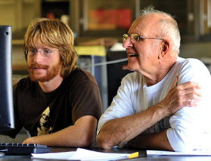 professor helps student with computer lesson