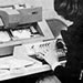 1975 photo of SUNY Plattsburgh student using an IBM 1660 punch card computer