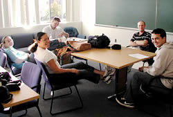 Students relaxing around a conference table