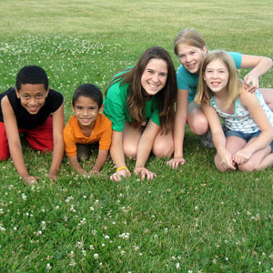 Photo of student with a group of children