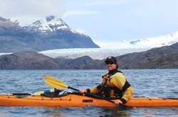 Photo of Dan Pond kayaking near a glacier