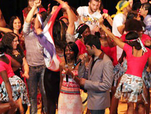 Photo of International students celebrating Night of Nations on stage in the E Glenn Giltz Auditorium.
