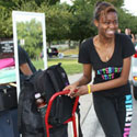 Photo of students carrying belongings to their dorms on Move-In Day