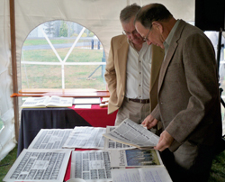 Delta Kappa Delta brothers look over memorabilia at a recent ceremony honoring members who have died and recognizing members' gifts to the college.