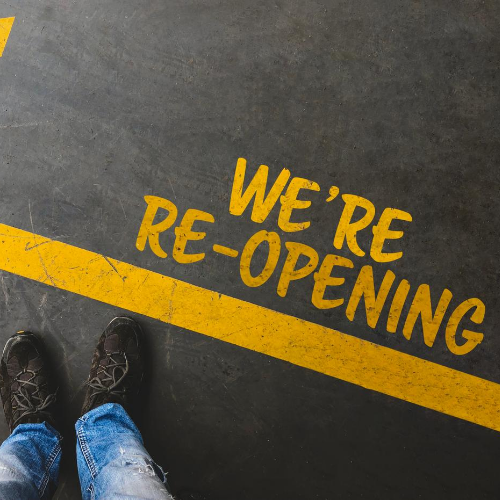 We're Reopening written on pavement
