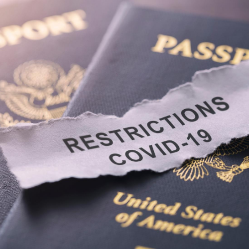 Passport with COVID-19 Restrictions written on top