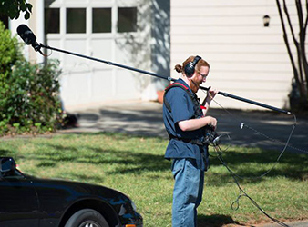 Jeffrey working in the field with sound equipment