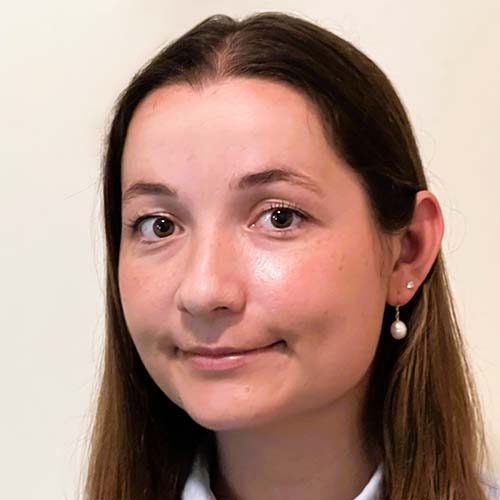Professional photo of woman with long, straight brown hair and a blue button-down shirt