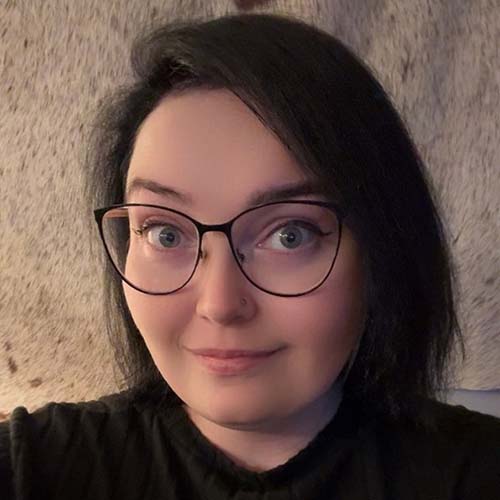 Woman with cat-eye glasses and dark hair
