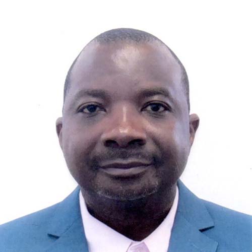 Passport-style headshot of Mr. Tidjani, wearing a suit and tie.