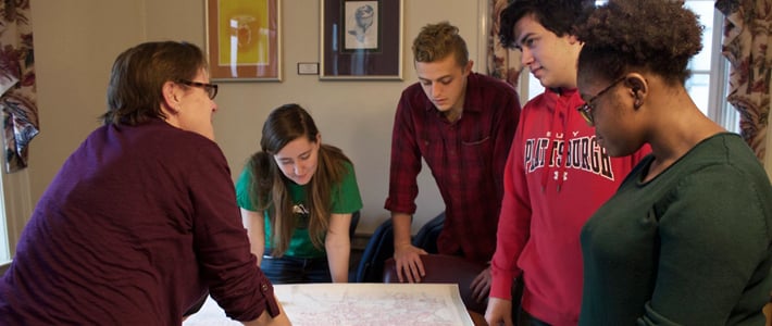 Dr. Wendy Gordon discusses a historical map with students