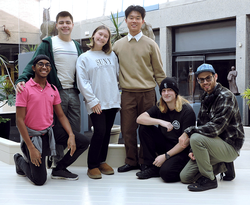 6 Students from the Music Arts Management program stand in an art gallery, posing for photo