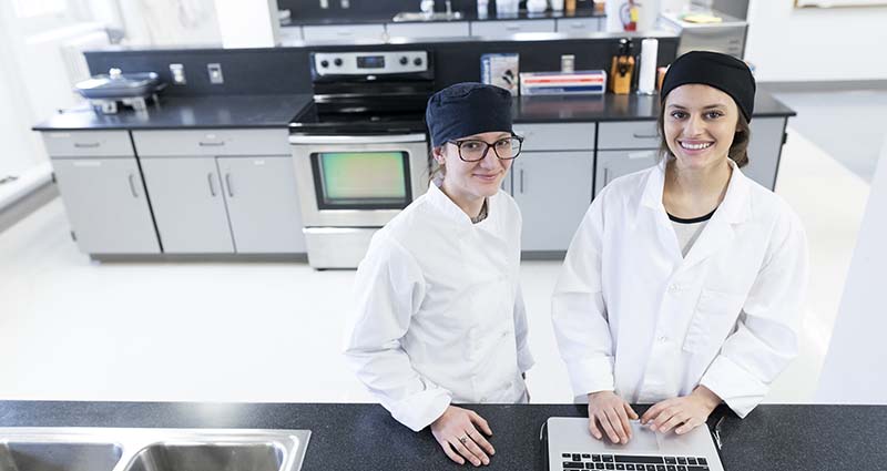 Female students in the nutrition lab using a computer