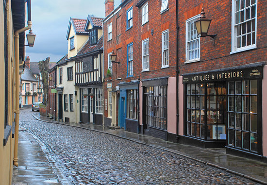 Old-fashioned shops in Norwich on a cobblestone street