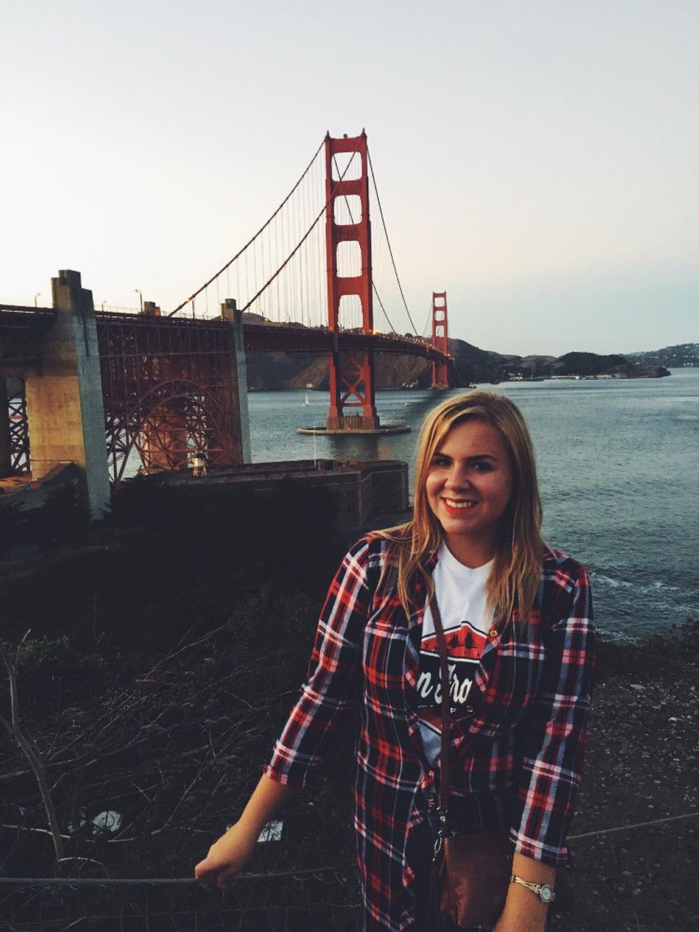 An NSE student poses in front of the Golden Gate Bridge