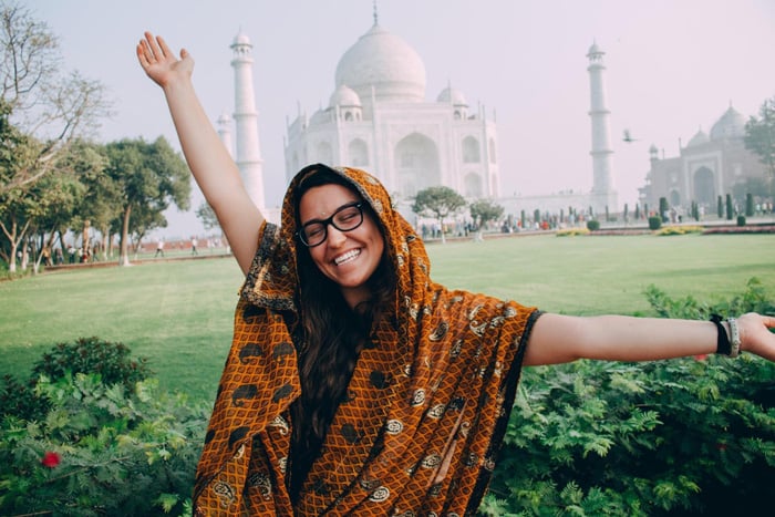 A Semester at Sea student poses in front of the Taj Mahal