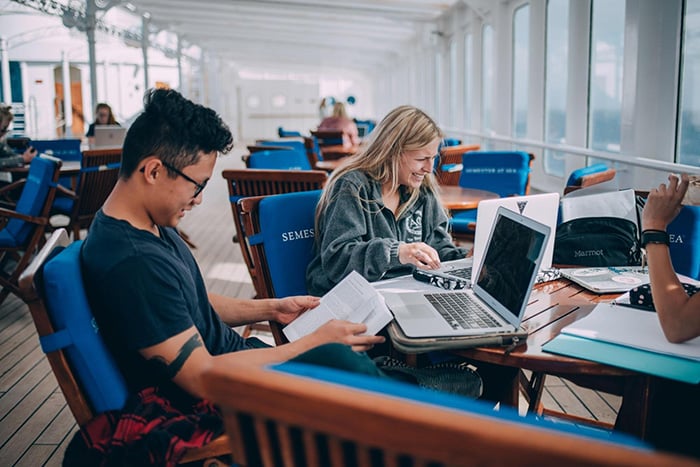 Semester at Sea students study on the ship's deck