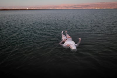 Image of a woman floating on a body of water