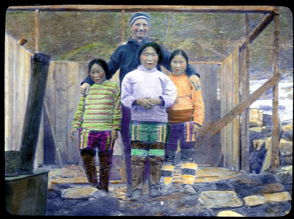 Tall man standing behind three women