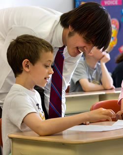 Photo of SUNY Plattsburgh education student working with students in a classroom