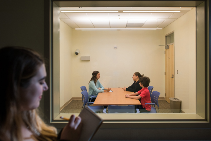 Photo of students working with family