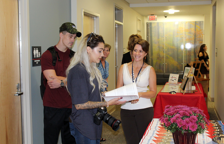 Photo shows group of visitors touring the facility