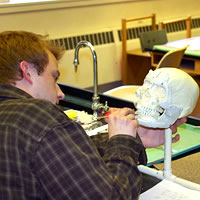 Photo of Ryan McCalla in the forensic anthropology lab