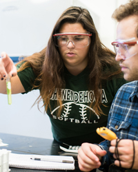 Photo of two students working in a lab
