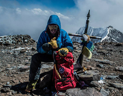 Photo of Charlie Stewart on a remote mountain top