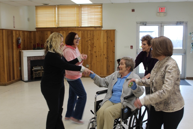 memory cafe dancing with wheelchair woman