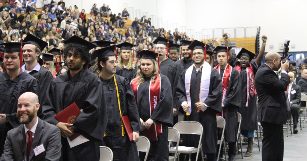 standing cheering grads