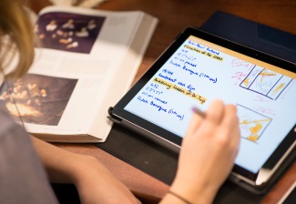 Photo of young woman drawing on a Chromebook