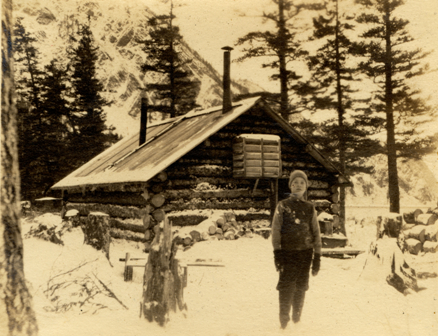 rocky in front of cabin